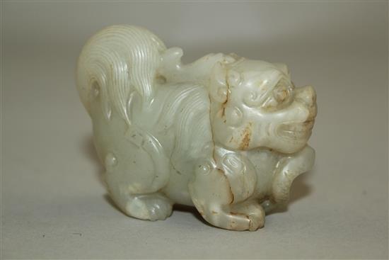 A Chinese pale celadon jade group of a lion-dog and a snake, 6.3cm